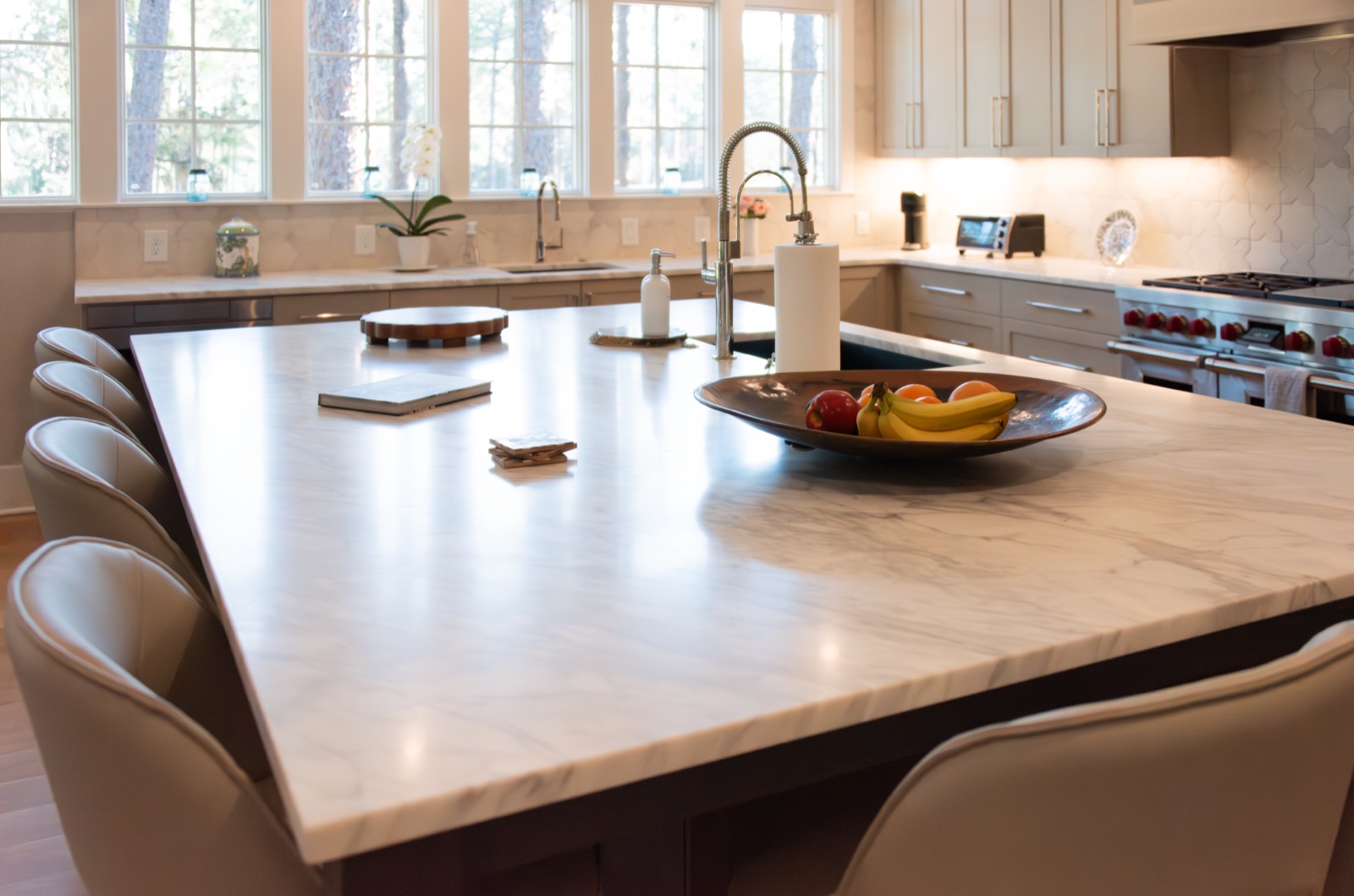 Kitchen island and range area with Calacatta Crema marble countertops